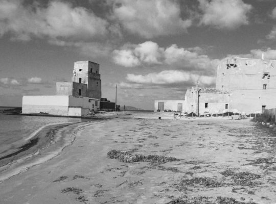 Black and white image of historic buildings on the Trapani coast, Sicily.